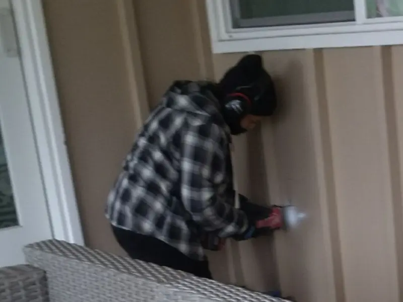 Professional electrician installing an exterior outlet in Dryden