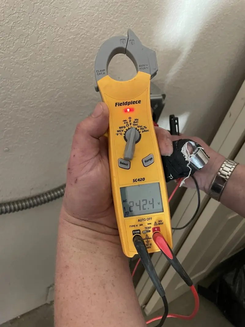 Voltage testing with clamp meter during Electrical Installation Services in Dryden